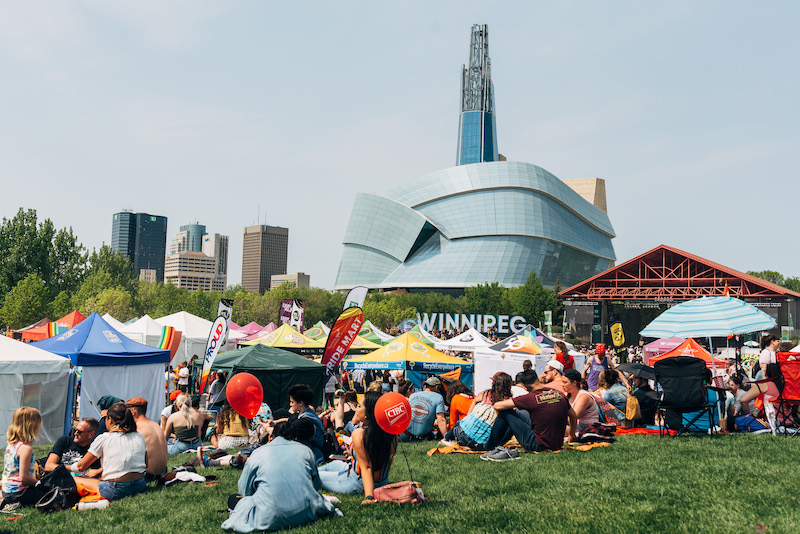 the pride festival at the forks and the human rights museum on the background