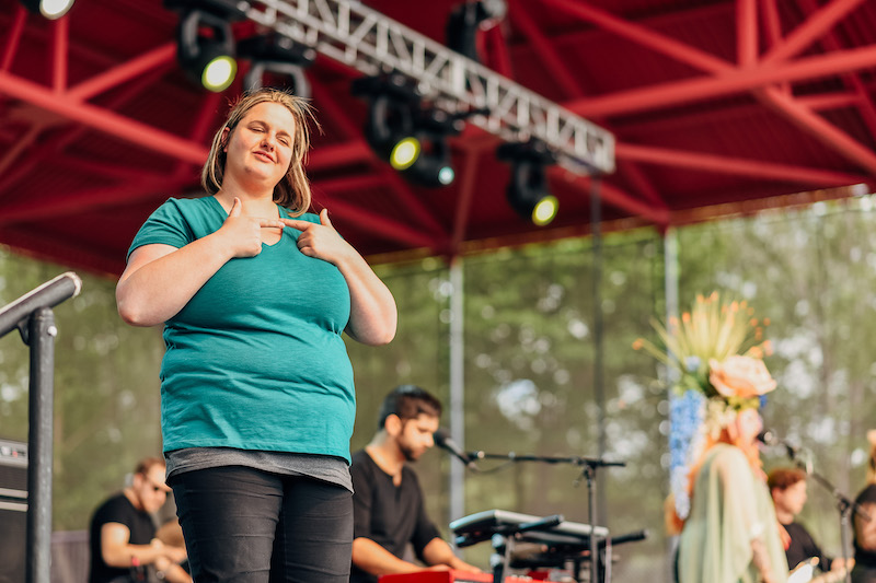 ASL interpreter on festival stage.